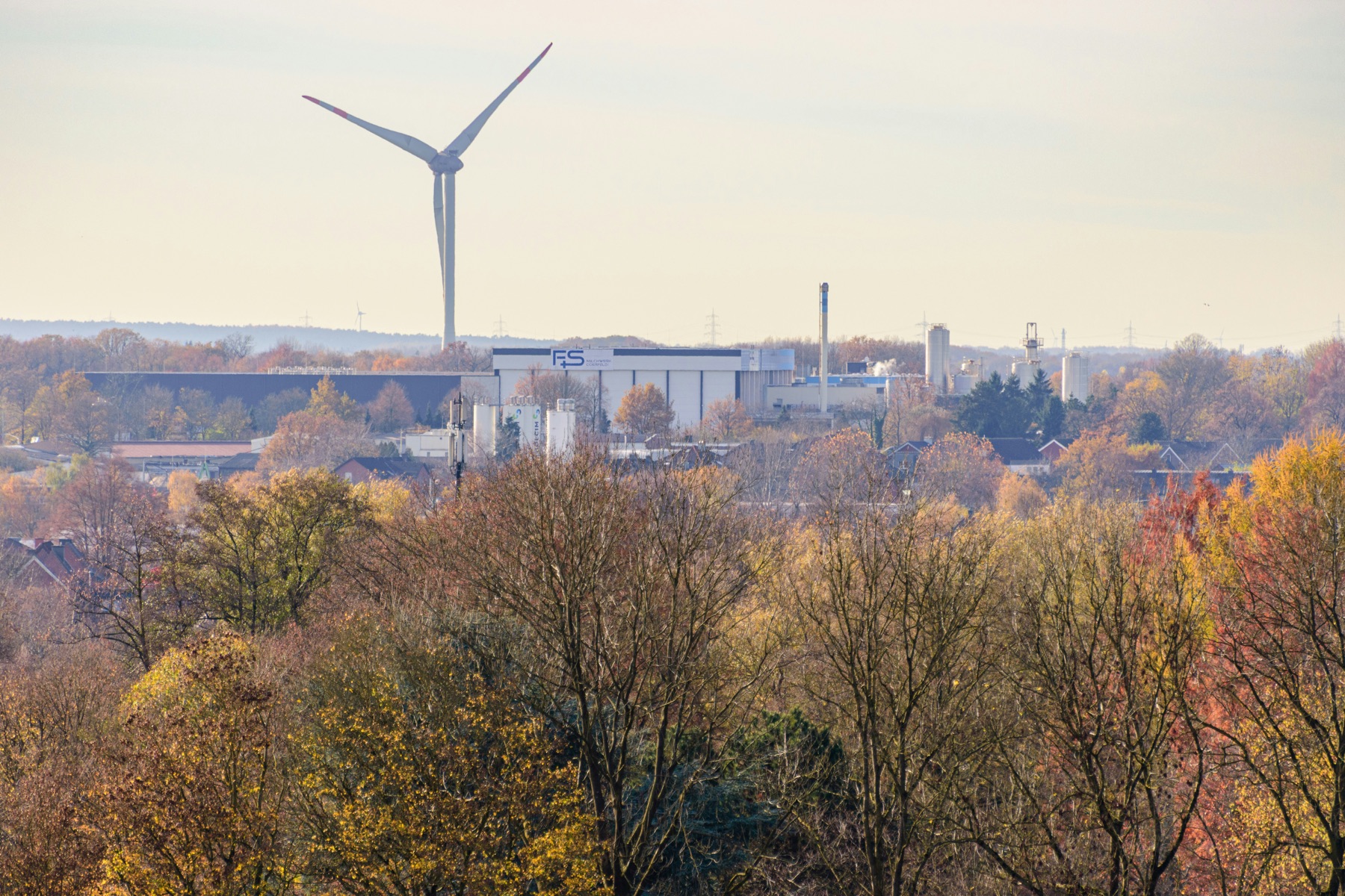 Wind turbine near industrial buildings